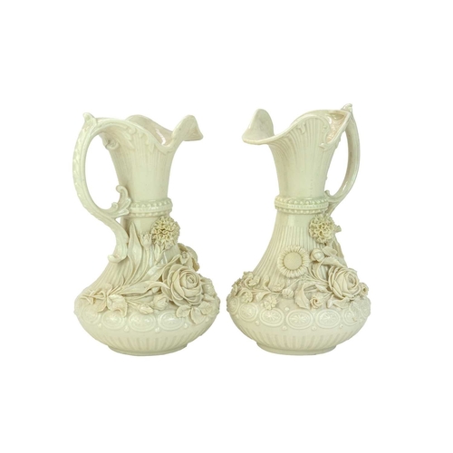 306 - A pair of Belleek 'Aberdeen' ewers. With floral encrusted decoration. Second period (1891-1926) fact... 