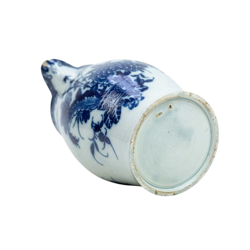 313 - A large pearlware jug. Circa 1800, painted in blue with floral and insect decoration, height 20cm.