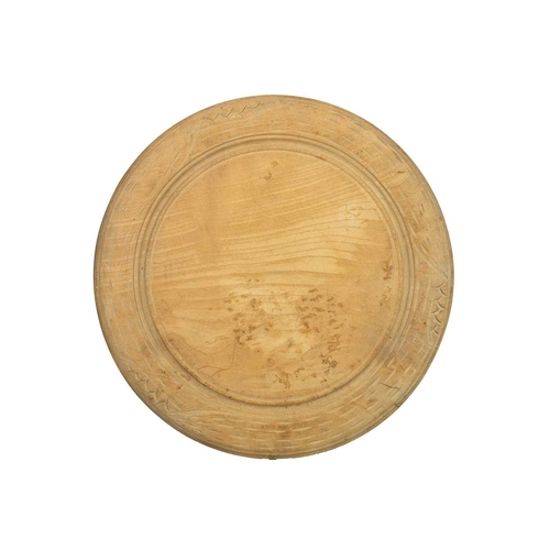 344 - A carved wood bread board. Diameter 30cm, with a W&T Avery marble effect pottery deli or butcher's p... 