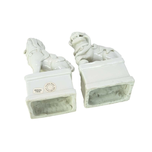 372 - A pair of Chinese blanc de chine Buddhistic lions. Qianlong, each beast rests its paw upon a ball, o... 