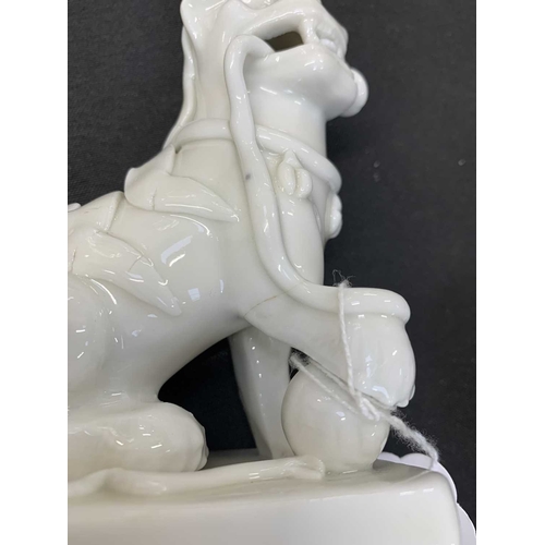 372 - A pair of Chinese blanc de chine Buddhistic lions. Qianlong, each beast rests its paw upon a ball, o... 