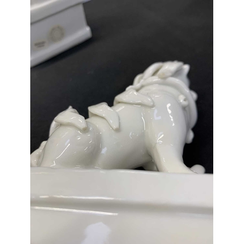 372 - A pair of Chinese blanc de chine Buddhistic lions. Qianlong, each beast rests its paw upon a ball, o... 