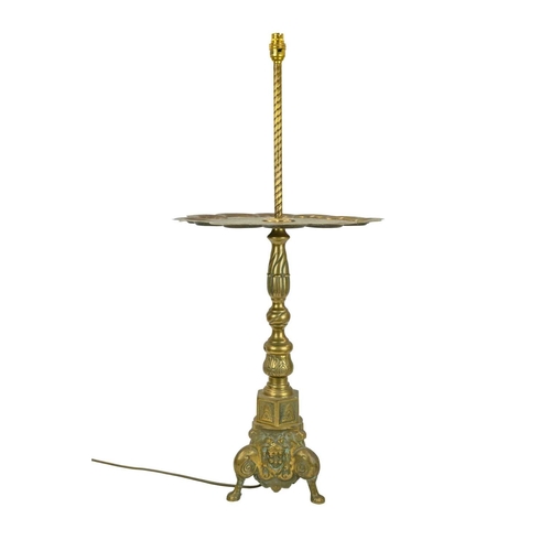38 - A brass side table with integrated lamp. With an Indian engraved Benares tray table top with scallop... 