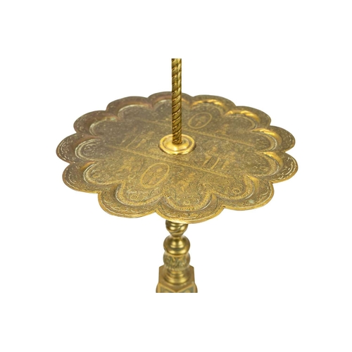 38 - A brass side table with integrated lamp. With an Indian engraved Benares tray table top with scallop... 