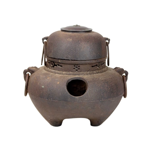 393 - A Japanese cast iron and copper chagama tea kettle. 19th century, of bellied form with ring handles ... 