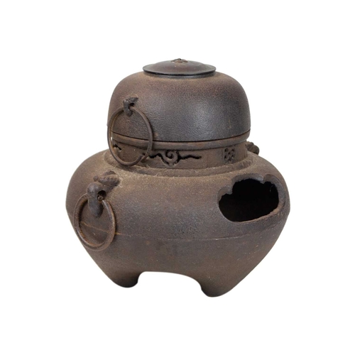 393 - A Japanese cast iron and copper chagama tea kettle. 19th century, of bellied form with ring handles ... 
