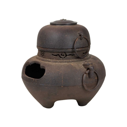 393 - A Japanese cast iron and copper chagama tea kettle. 19th century, of bellied form with ring handles ... 