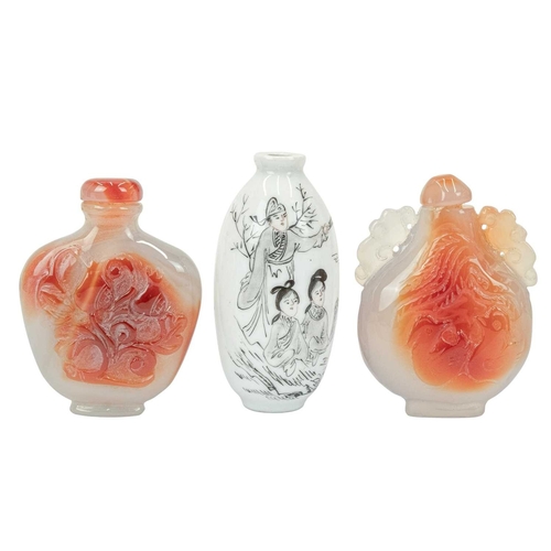394 - Three Chinese snuff bottles. 19th/20th century, an ovoid porcelain example, painted with figures in ... 