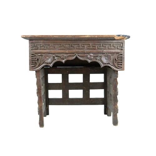 395 - A Chinese hardwood folding table. Circa 1900, the top and frieze carved with dragons on folding supp... 