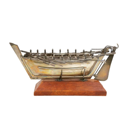 413 - A Middle Eastern silver model of a rowing boat. With eight pairs of oars and a tiller, length 20.5cm... 