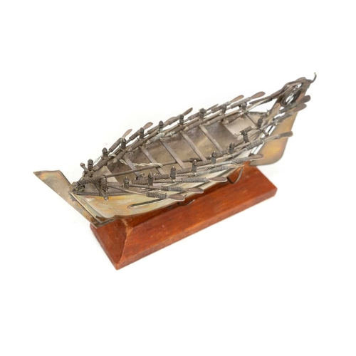 413 - A Middle Eastern silver model of a rowing boat. With eight pairs of oars and a tiller, length 20.5cm... 