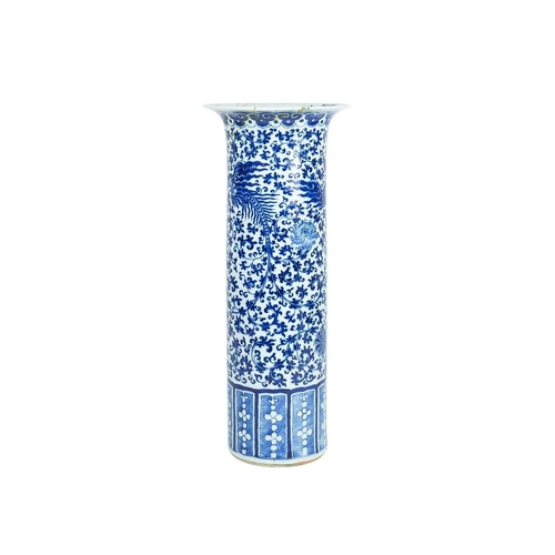 423 - A Chinese blue and white cylinder vase. Late Qing, with a slightly everted rim, painted with dragons... 