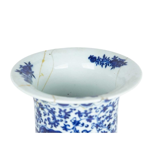 423 - A Chinese blue and white cylinder vase. Late Qing, with a slightly everted rim, painted with dragons... 