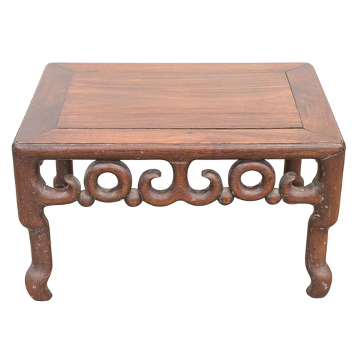 438 - A Chinese hardwood stand or low table. Early 20th century, with an open pierced and moulded frieze, ... 