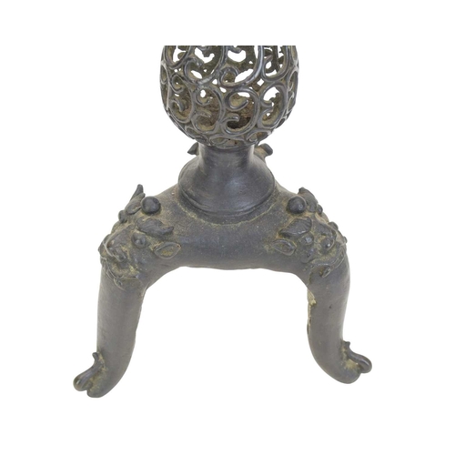 445 - A Chinese bronze altar candlestick, probably Ming Dynasty, 17th century. The stem with pierced scrol... 