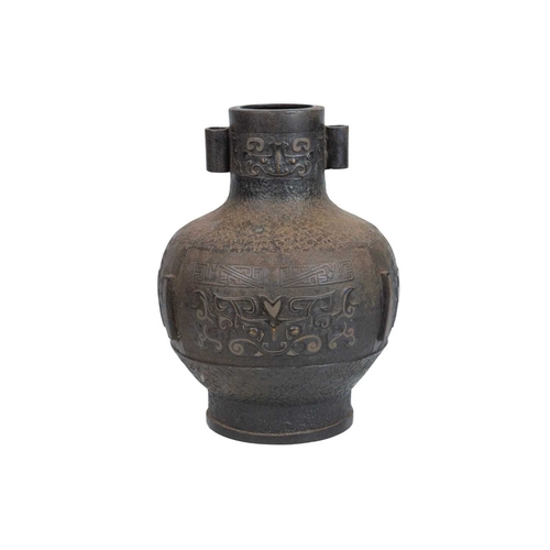446 - A Chinese bronze Archaic style Hu vase. Late Qing, with cast and inlaid decoration, twin lug handles... 