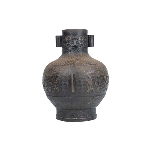 446 - A Chinese bronze Archaic style Hu vase. Late Qing, with cast and inlaid decoration, twin lug handles... 