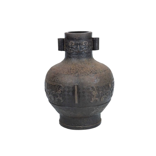 446 - A Chinese bronze Archaic style Hu vase. Late Qing, with cast and inlaid decoration, twin lug handles... 