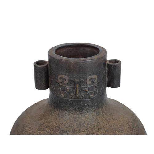 446 - A Chinese bronze Archaic style Hu vase. Late Qing, with cast and inlaid decoration, twin lug handles... 
