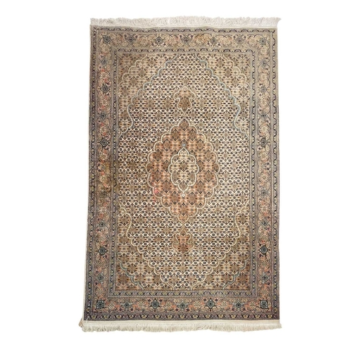 468 - A wool pile Tabriz rug. In muted tones, central scalloped medallion within floral borders, 166cm x 1... 