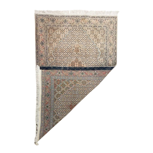 468 - A wool pile Tabriz rug. In muted tones, central scalloped medallion within floral borders, 166cm x 1... 