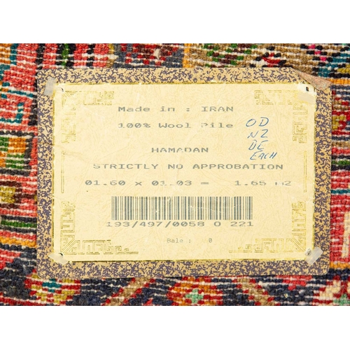 477 - A Hamadan wool rug, Late 20th century, made in Iran, wool pile on cotton, 158cm x 102cm.