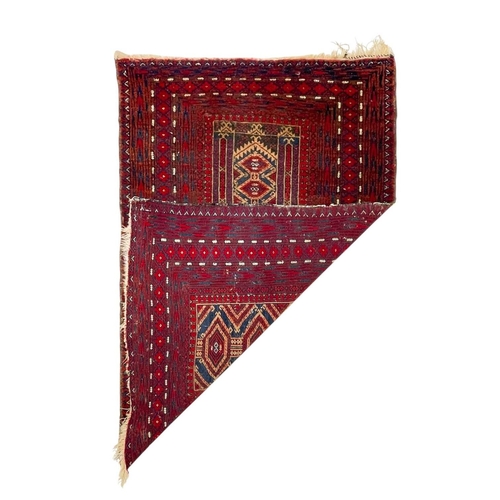 491 - An Afghan wool prayer rug. Red ground, geometric central panel within multiple borders, 142cm x 96cm... 