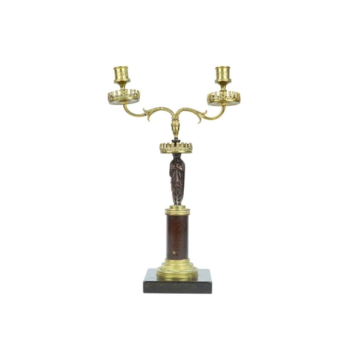 52 - A bronze and ormolu figural candelabrum. 19th century, twin branches with a draped female figure sta... 