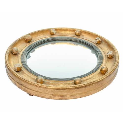 520 - A 19th century giltwood convex mirror. With circular plate and reeded ebonised slip. Diameter 29cm. ... 