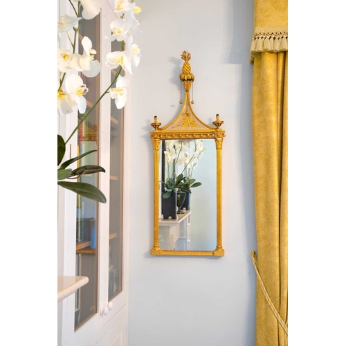 522 - A pair of giltwood and verre eglomise mirrors or pier glasses. Circa 1900, the swept tops with paint... 