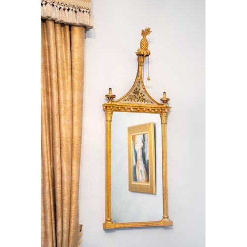 522 - A pair of giltwood and verre eglomise mirrors or pier glasses. Circa 1900, the swept tops with paint... 