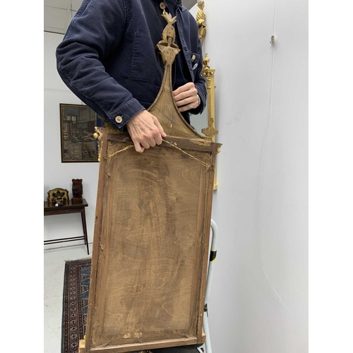 522 - A pair of giltwood and verre eglomise mirrors or pier glasses. Circa 1900, the swept tops with paint... 