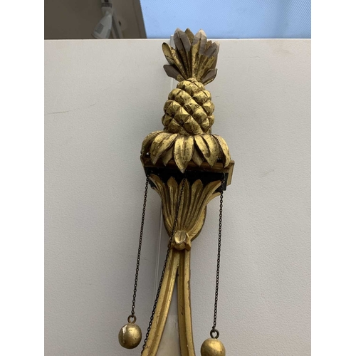 522 - A pair of giltwood and verre eglomise mirrors or pier glasses. Circa 1900, the swept tops with paint... 