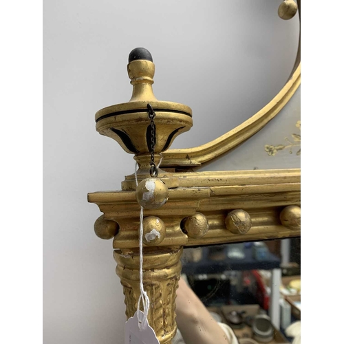 522 - A pair of giltwood and verre eglomise mirrors or pier glasses. Circa 1900, the swept tops with paint... 