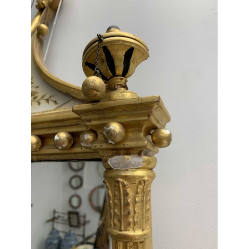 522 - A pair of giltwood and verre eglomise mirrors or pier glasses. Circa 1900, the swept tops with paint... 