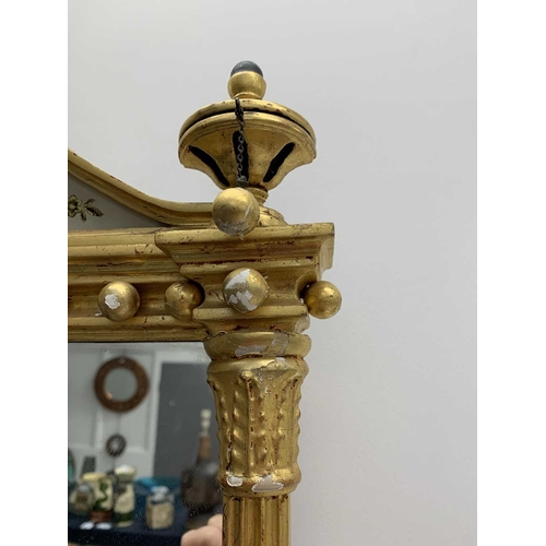 522 - A pair of giltwood and verre eglomise mirrors or pier glasses. Circa 1900, the swept tops with paint... 