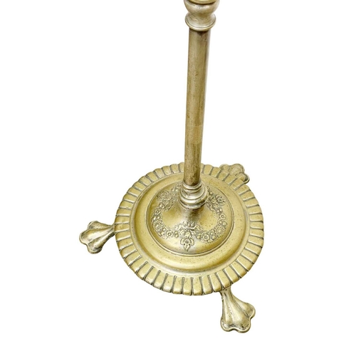 524 - A Victorian brass standard oil lamp. Raised on a circular cast base with three lion's paw feet, with... 