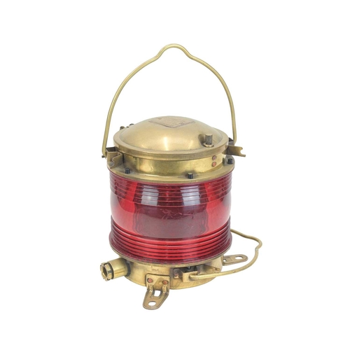 526 - A brass-cased nautical light. By Japanese company Nippon Sento Co Ltd, ribbed red plastic, with bras... 