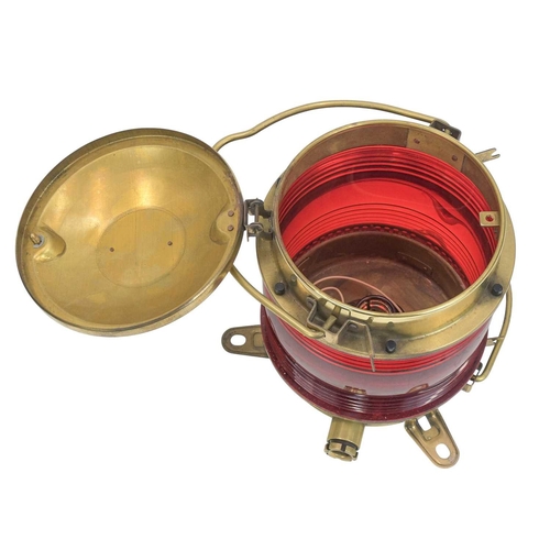 526 - A brass-cased nautical light. By Japanese company Nippon Sento Co Ltd, ribbed red plastic, with bras... 