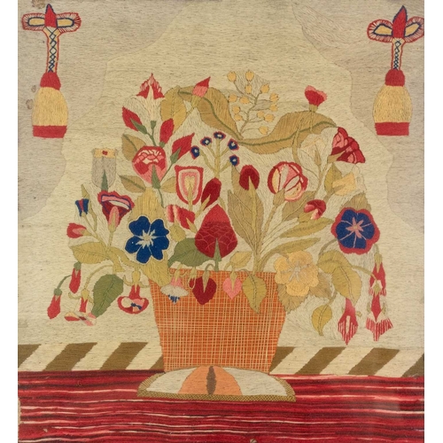 561 - A Regency needlepoint embroidered picture. Worked with a basket of flowers, 41 x 37cm, in a maple fr... 