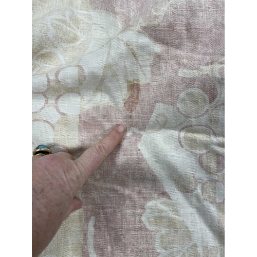 570 - A pair of linen curtains. Patterned with fruiting vine leaves in pink and beige, pleat top with cott... 