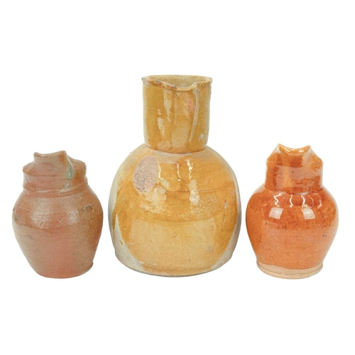 593 - A French mustard glaze terracotta jug. Circa 1900, with a pinched spout and loop handle, height 25cm... 