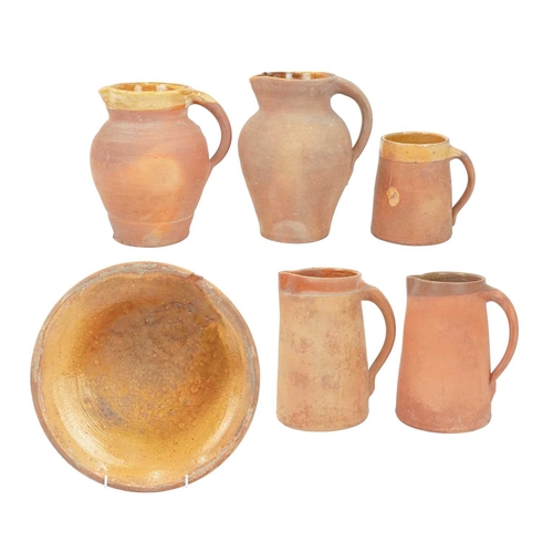 599 - Lakes Cornish pottery, Truro. Three terracotta jugs, the largest 20.5cm, all marked, together with a... 