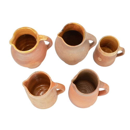 599 - Lakes Cornish pottery, Truro. Three terracotta jugs, the largest 20.5cm, all marked, together with a... 