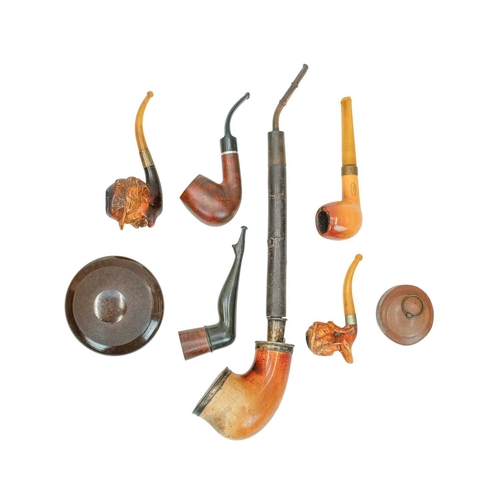 60 - A small collection of pipes. Including two Meerschaum head examples, one with inset eyes, four other... 