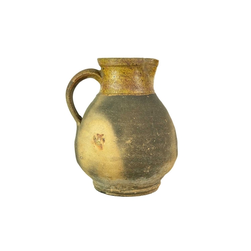 604 - A Verwood (Dorset) pottery jug. Late 19th century, with part glazed body, height 21cm.