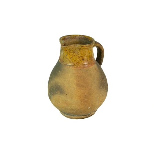 604 - A Verwood (Dorset) pottery jug. Late 19th century, with part glazed body, height 21cm.