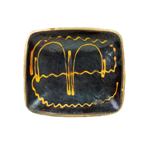 612 - A slipware rectangular dish. 18th century, with a honey coloured trailed pattern on a deep brown gro... 