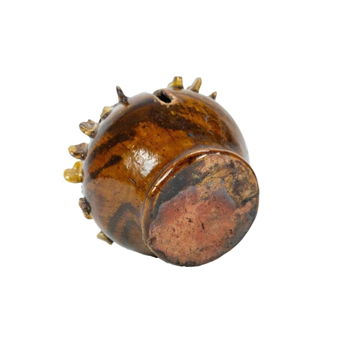 614 - A treacle glazed agateware money box. Possibly Yorkshire, 19th century, of baluster shape, applied w... 