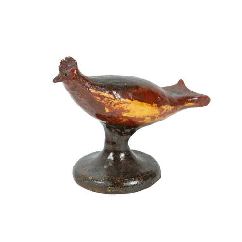 626 - A primitive slipware pottery bird whistle. Early-mid 19th century, on a waisted circular base, heigh... 